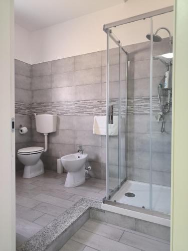 a bathroom with a glass shower and a toilet at Hotel 4 Lampioni in Cropani