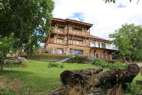 a large building with balconies on top of a yard at Domeniul Mortasifu in Nişcov