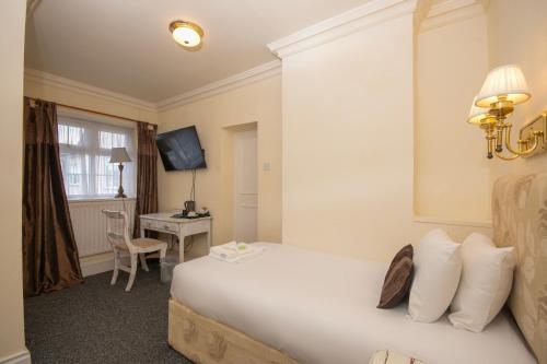 a hotel room with a bed and a desk at Northop Hall Country House Hotel in Mold