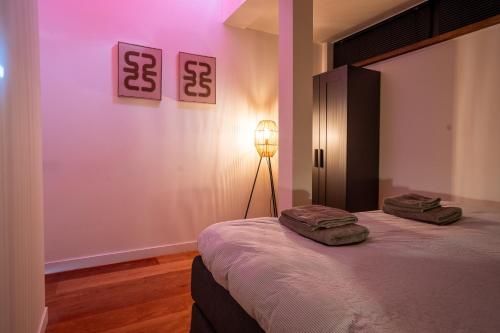 a bedroom with a bed with two towels on it at Noard 41 in Workum