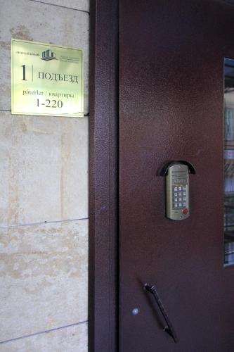 a door with a cell phone on it at Almaty Cozy Apart Hotel in Almaty