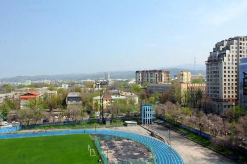 a view of a city with a park and buildings at Almaty Cozy Apart Hotel in Almaty