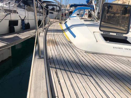 a white boat is docked at a dock at Entire boat 3 cabins in Birgu vittoriosa in Birgu