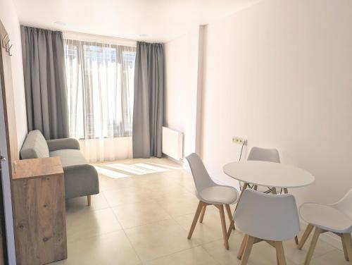 a living room with a table and chairs at Cosy At Home in K'obulet'i