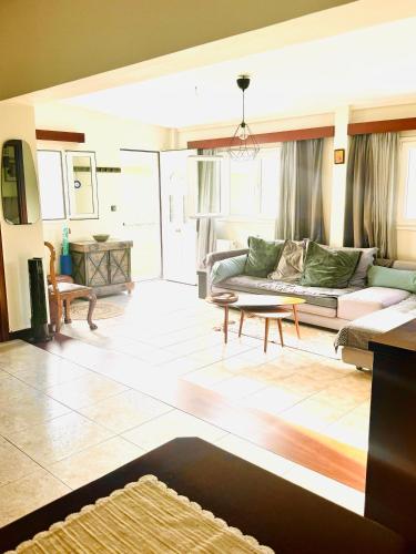 a living room with a couch and a table at Villa Katerina in Kos
