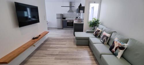 a living room with a couch and a television at Azure Sunset in Ponta Delgada