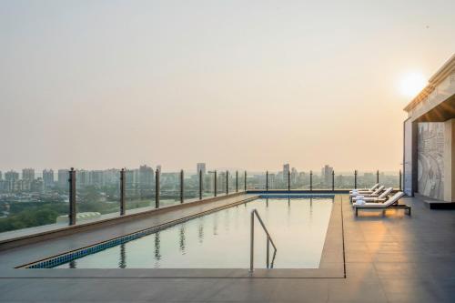 a swimming pool on the top of a building at Navi Mumbai Marriott in Navi Mumbai