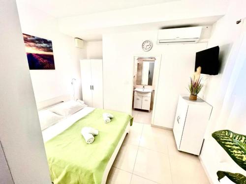 a small room with a green bed in it at Morska in Orebić