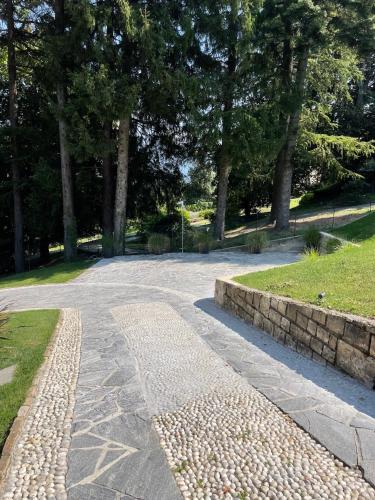 a stone path in a park with trees at The Iconic Lodge in Bellagio