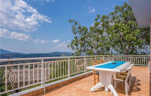 a white table and chairs on a balcony with a view at Lovely Home In Patra With Kitchen in Patra