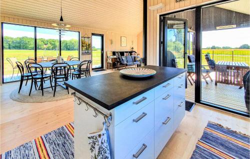 an open kitchen and dining area of a house at Awesome Home In Förslöv With Wifi in Förslöv