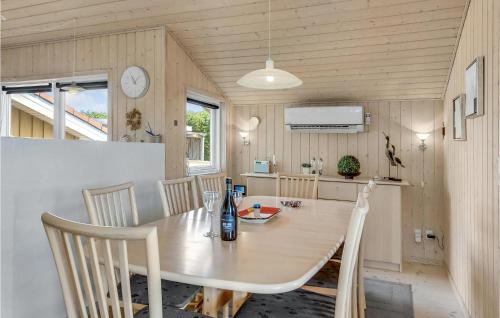 a kitchen and dining room with a table and chairs at Holiday Home Råde Strandpark Ix in Årøsund