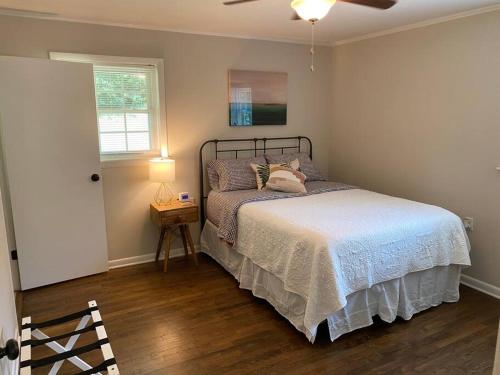 a bedroom with a bed and a lamp and a window at Pine Valley Place 3 Bedroom 2 Bathroom house in Gainesville