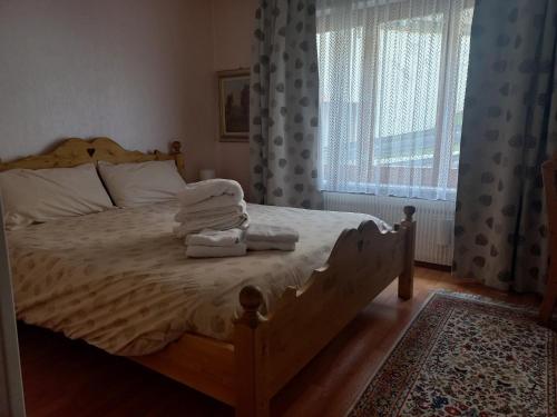 a bedroom with a bed with towels on it at Apartment 24 Hotel Etrier pool & spa in Crans-Montana