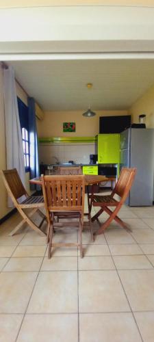 a dining room with a table and two chairs at Vacances martinique in Sainte-Anne