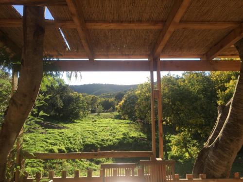 a view of a field from the porch of a house at Au Paradis des Campeurs in Les Issambres