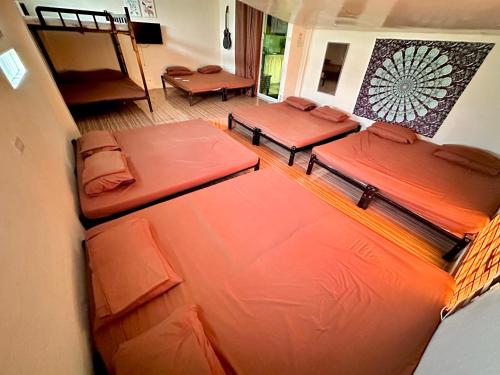 a room with three beds sitting in it at Transient House in Pili, Camarines Sur Bicol in Pili