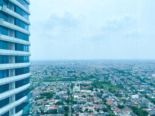 an aerial view of a city from a building at Modern Look 2BR at Grand Kamala Lagoon Apartment By Travelio in Bekasi