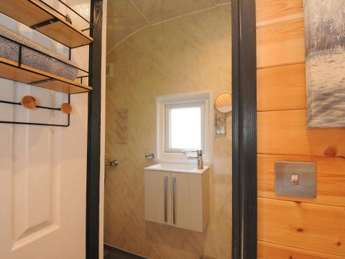 a small bathroom with a sink and a window at Hornbeam in Launceston