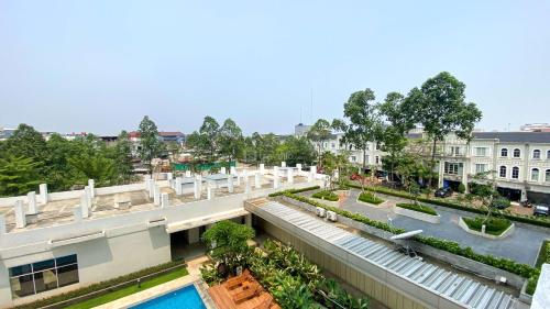 an aerial view of a building with a swimming pool at Good and Comfy 1BR (No Kitchen) at Citra Living Apartment By Travelio in Jakarta