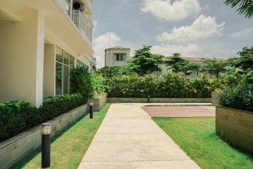 a walkway in front of a building at Good and Comfy 1BR (No Kitchen) at Citra Living Apartment By Travelio in Jakarta