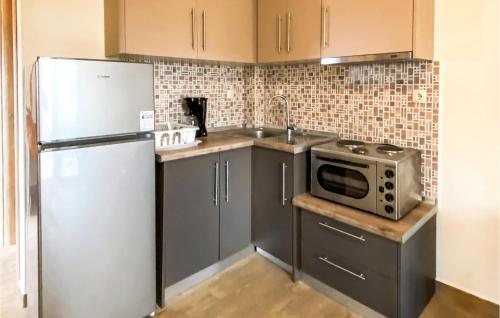 una cocina con nevera y microondas en 2 Bedroom Cozy Apartment In Nafpaktos, en Nafpaktos