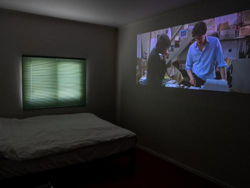 a bedroom with a bed and a tv on the wall at Chungking Mansions Busan in Busan