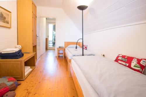 a bedroom with two beds and a desk and a table at Villa Sajkod in Tihany