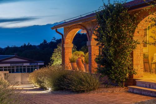 a brick building with an arched entry way at Residence Apolonija Guest House in Sežana
