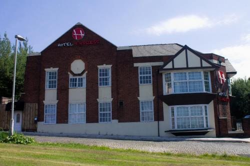 a red brick building with a sign on it at Hotel Express Newcastle Gateshead in Newcastle upon Tyne