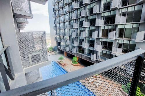 a balcony of a building with a swimming pool at Best Deal and Homey 1BR Apartment Carstensz Residence By Travelio in Kampung Sawah