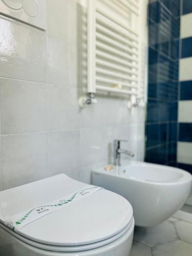 a bathroom with a white toilet and a sink at B&B Casa di Emma in Porto Cesareo
