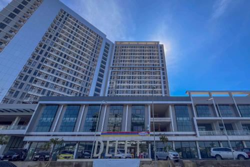 a tall building with cars parked in front of it at Good Choice Studio at Delft Ciputra Makassar Apartment By Travelio in Sungguminasa