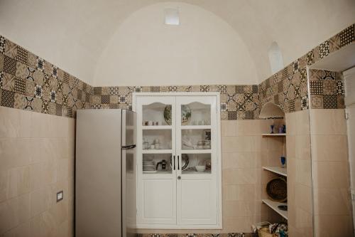 a kitchen with a white refrigerator in a room at Houch ZanZouri in Houmt Souk