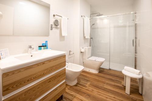 a bathroom with a sink and a toilet and a shower at Alcossebre Sea Experience in Alcossebre