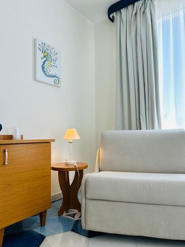 a living room with a couch and a table at B&B Casa di Emma in Porto Cesareo