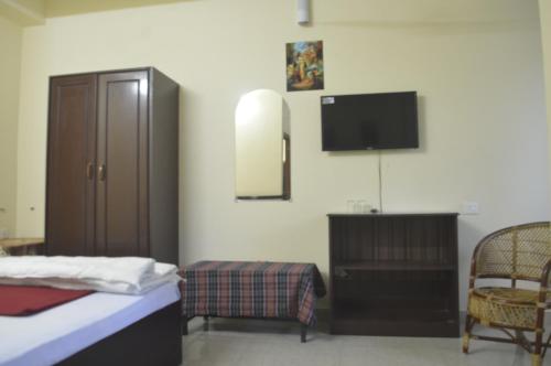 Postel nebo postele na pokoji v ubytování Green Castle Residency