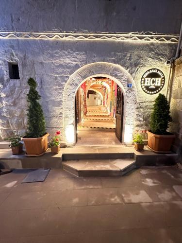 a tunnel with a staircase in a building with plants at Hira Cave Hotel in Goreme