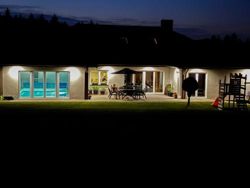 a house with a view of the ocean at night at Siedlisko Błotnia in Mierzeszyn
