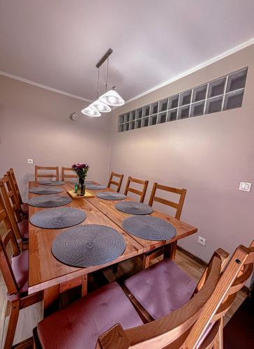 a room with a long wooden table and chairs at Siedlisko Błotnia in Mierzeszyn