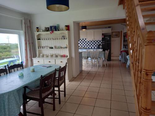 a kitchen and dining room with a table and chairs at Pet friendly Sea side house in Connemara in Clifden