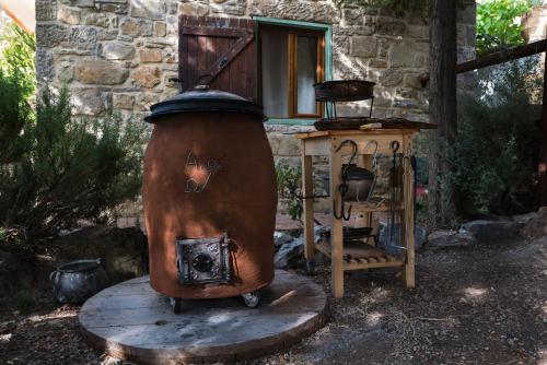 an old fire hydrant sitting in front of a building at Akros Oreon, Omalos Studio in Káto Sími