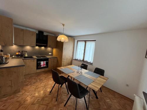 a kitchen and dining room with a table and chairs at Zell Views Apartments in Zell am Ziller