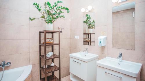 a bathroom with a sink and a toilet and a mirror at Malkia Penzion in Orechová Potôň