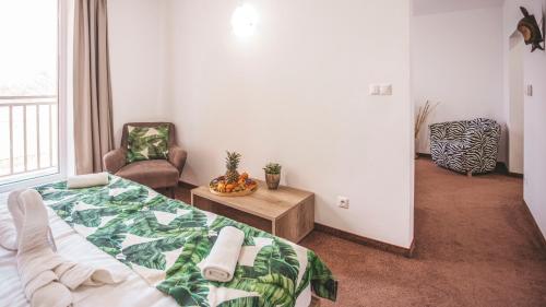 a bedroom with a bed and a chair at Malkia Penzion in Orechová Potôň
