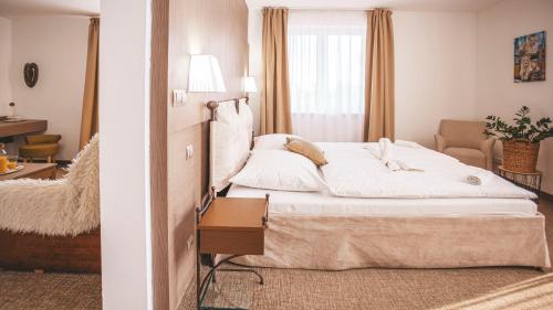 a hotel room with a bed and a mirror at Malkia Penzion in Orechová Potôň