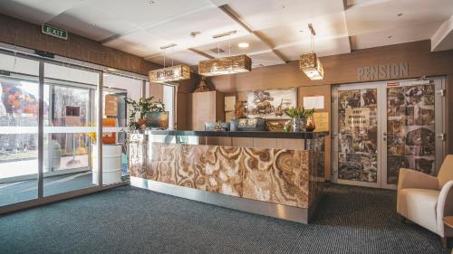 a lobby of a building with a reception counter at Malkia Penzion in Orechová Potôň