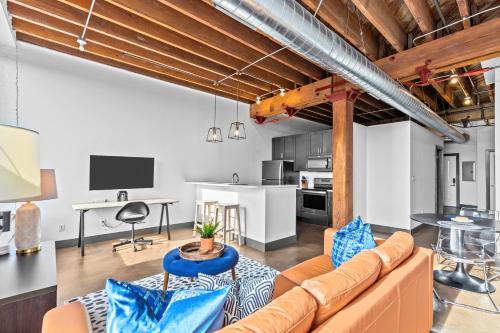 un soggiorno con un divano e un tavolo di Riverfront Loft-Parking-Gym-Deck-4I a Saint Louis