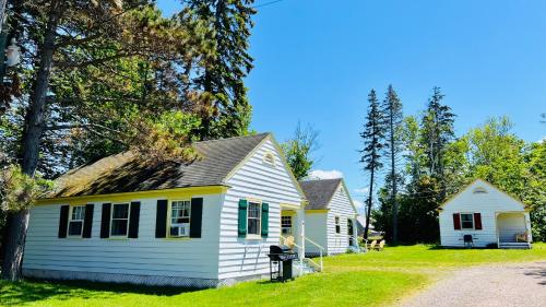 a house with a yellow and white house at Green Gables Bungalow Court in Cavendish