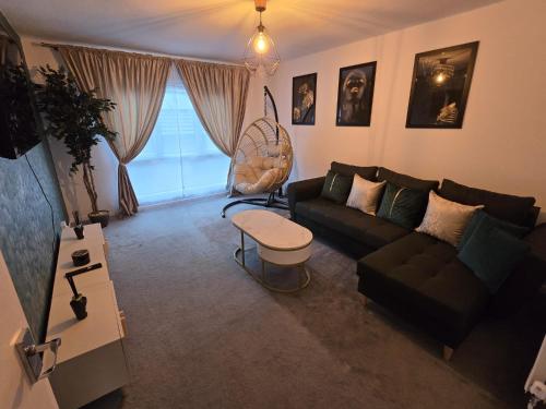 a living room with a couch and a chair at Cosy Home City Centre with free parking in Nottingham